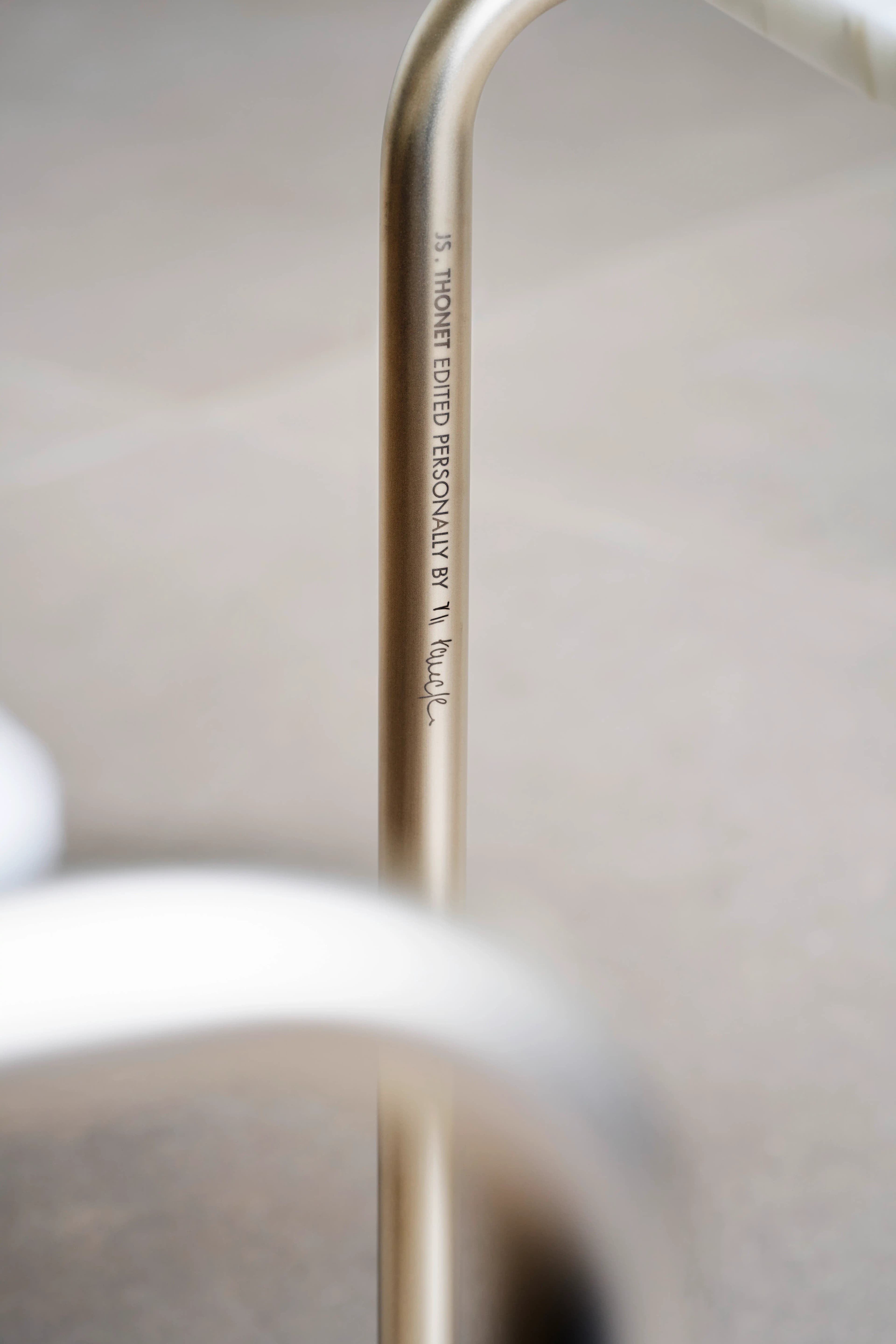 Editorial image for JS . THONET: Engraving on tubular steel frame: “JS. THONET EDITED PERSONALLY BY Jil Sander” with a signature.