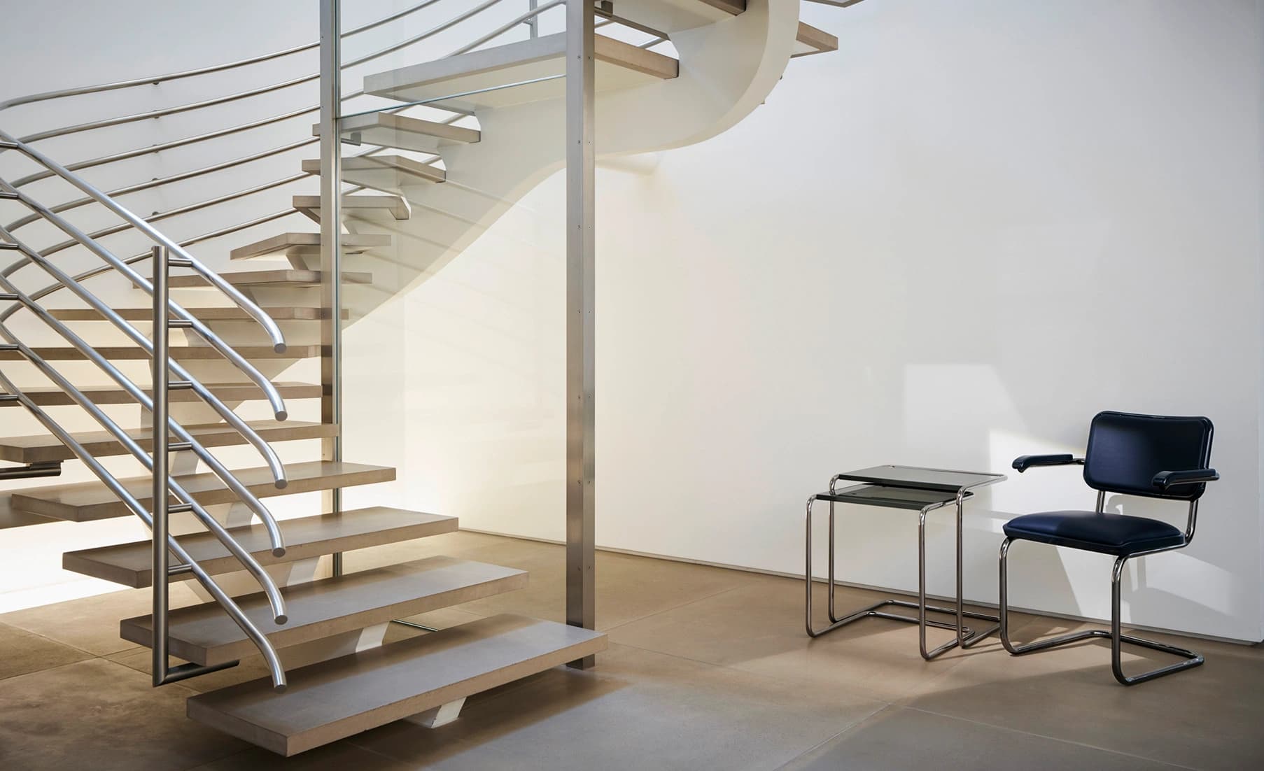 Editorial image for JS . THONET: S 64 SERIOUS cantilever chair with leather upholstery next to the B 97 side table set.