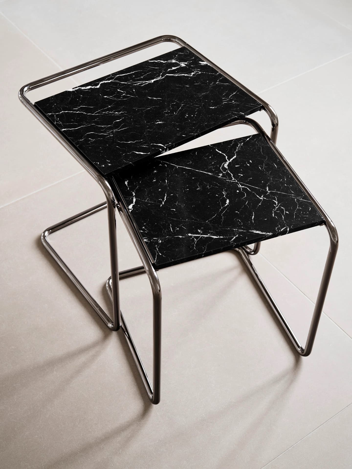 Detail shot for JS . THONET: B 97 nesting side table set with black marble tops and tubular steel frame.